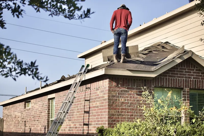 Professional roofer working on a residential roof in Kantner